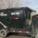 TNT Rolloffs black roll-off dumpster rental trailer in Franklin Indiana