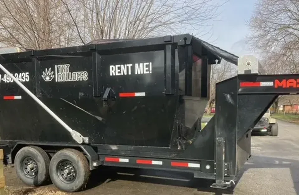 TNT Rolloffs black roll-off dumpster rental trailer in Franklin Indiana