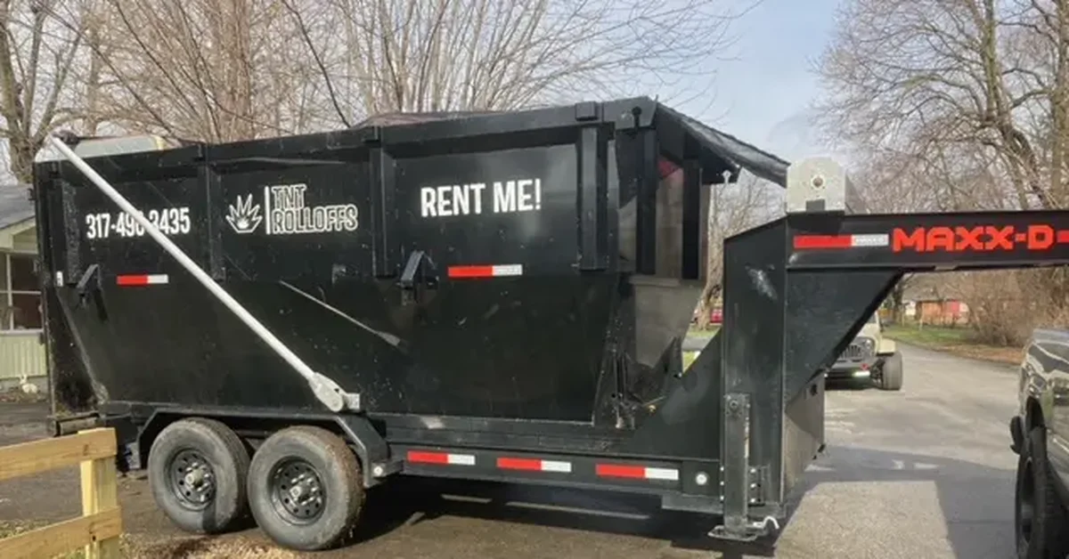 TNT Rolloffs black roll-off dumpster rental trailer in Franklin Indiana